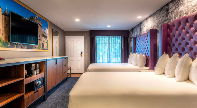 Newly renovated double queen room with purple headboards